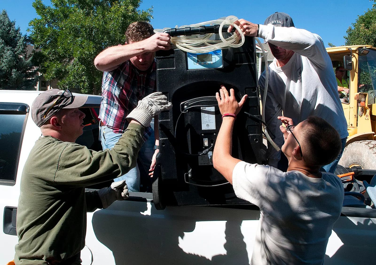 A crew loading a commercial dehumidifier after a flood. Shown on the homepage for Lakeland, FL.